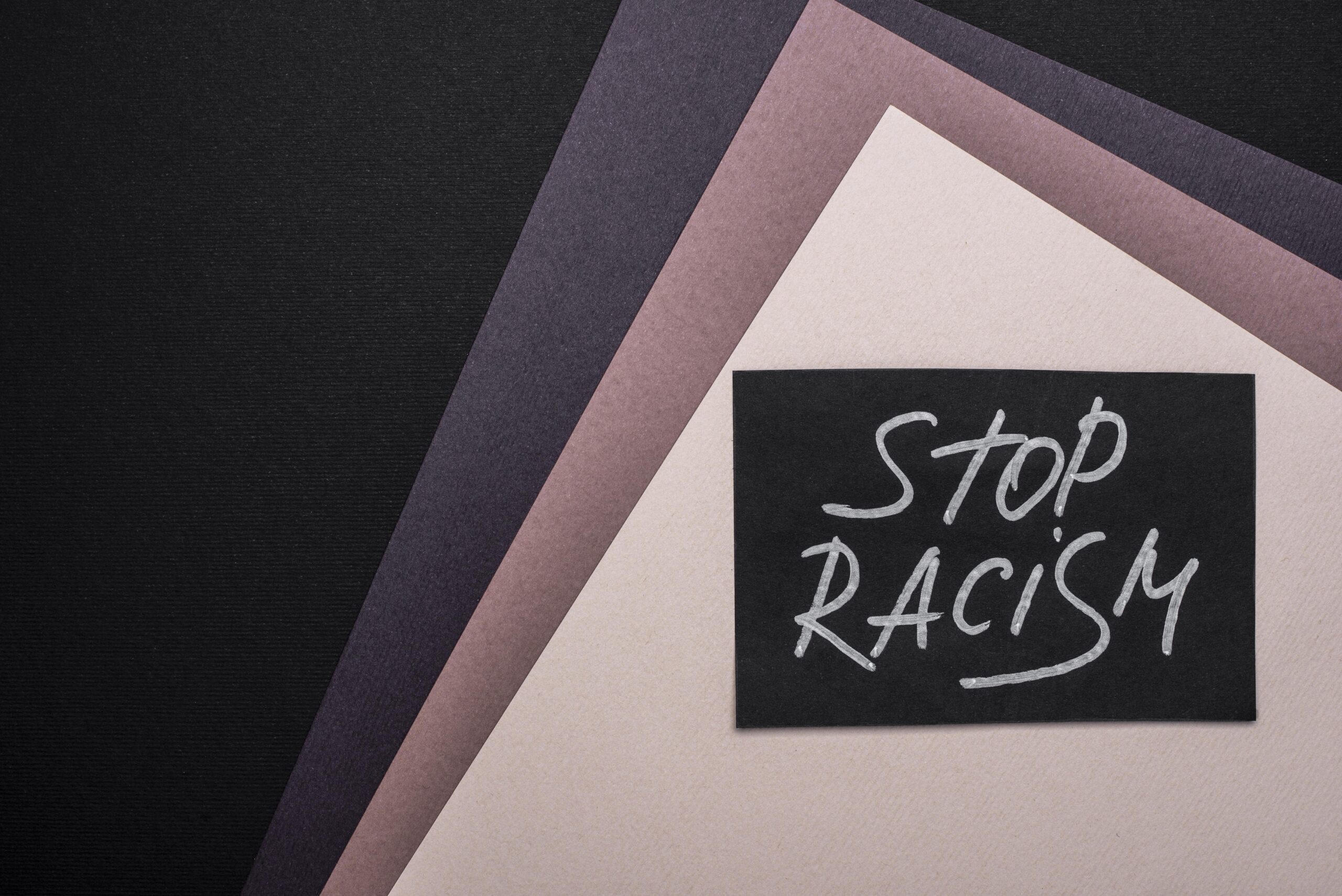 flat-lay-stop-racism-card-multicolored-paper-with-copy-space